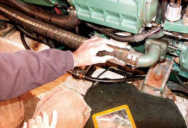 A hand holds onto a boat hose