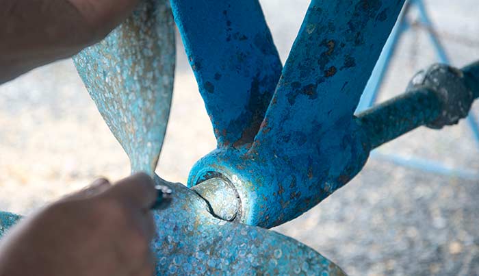 A close up of a rusty propeller