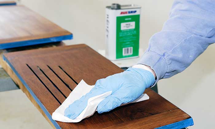 Cleaning surface with solvent before varnishing