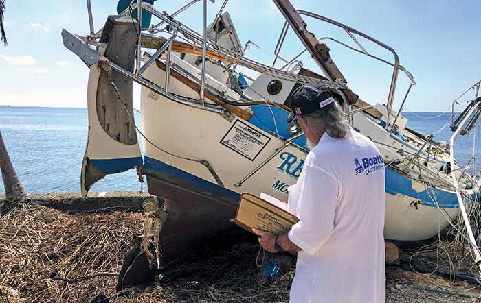 Surveying hurricane damaged boat