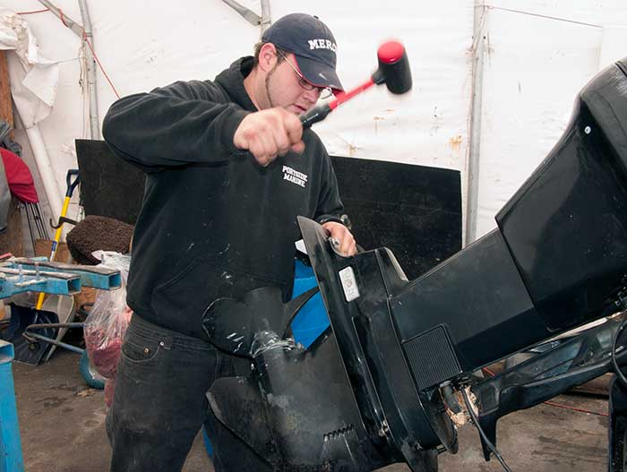 Using mallet to free lower unit