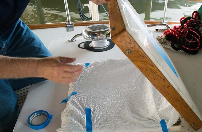 Tape sheet of plastic under hatch