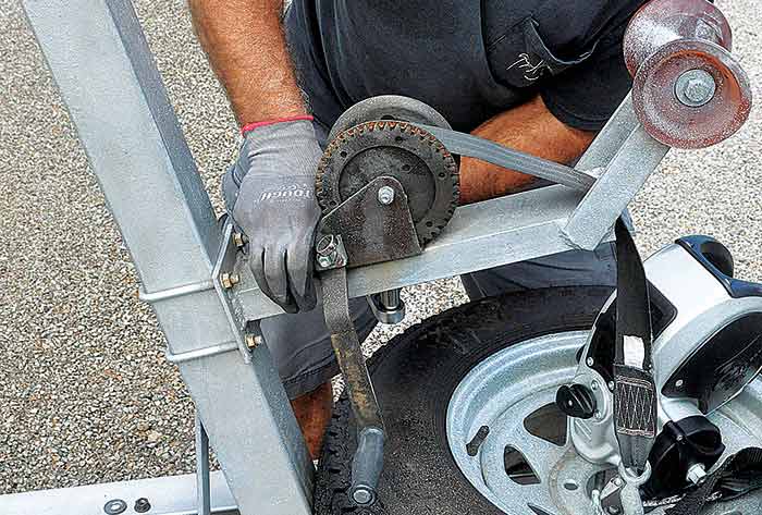 Removing bolts securing old winch