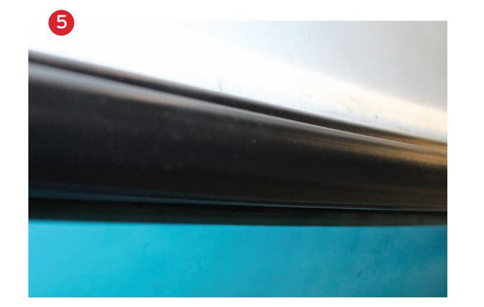 Black vinyl rubrail on the side of a boat