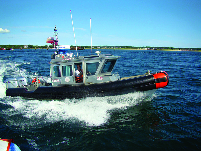 A canal boat in action keeping traffic in line on a sunny day.