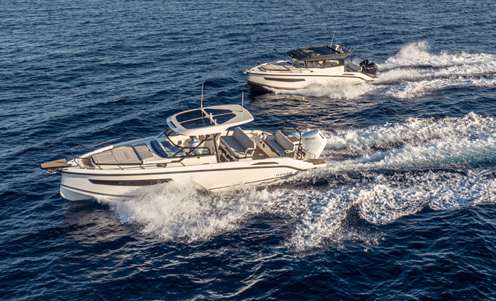 Two white boats speeding across open waters.