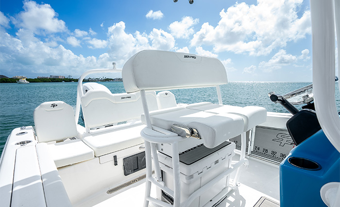 All white cockpit seating on a vessel out on the water on a sunny day.