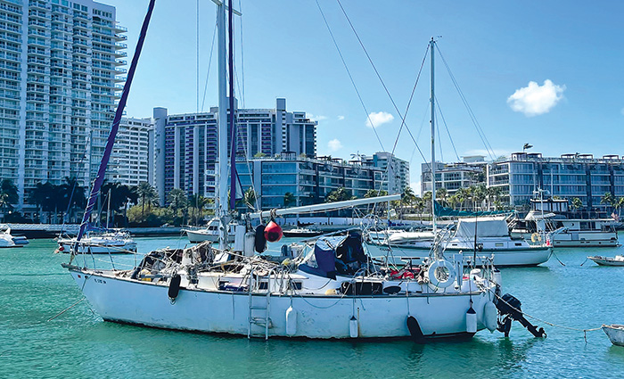 Large white sail boat off the coast of Miami on a sunny day.