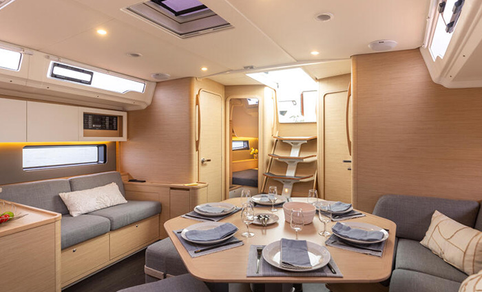 Octagon dining table set for dinner with gray loveseat and sitting area 