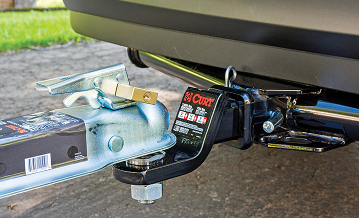 Up-close view of a trailer hitch and boat trailer tongue.