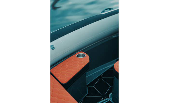 View of an orange and silver cupholder vessel RIB.