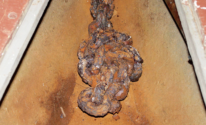 Severely rusted anchor and chain.