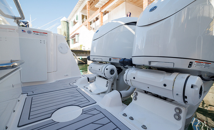 Swim platform on a white vessel featuring a walkway and dual motors.
