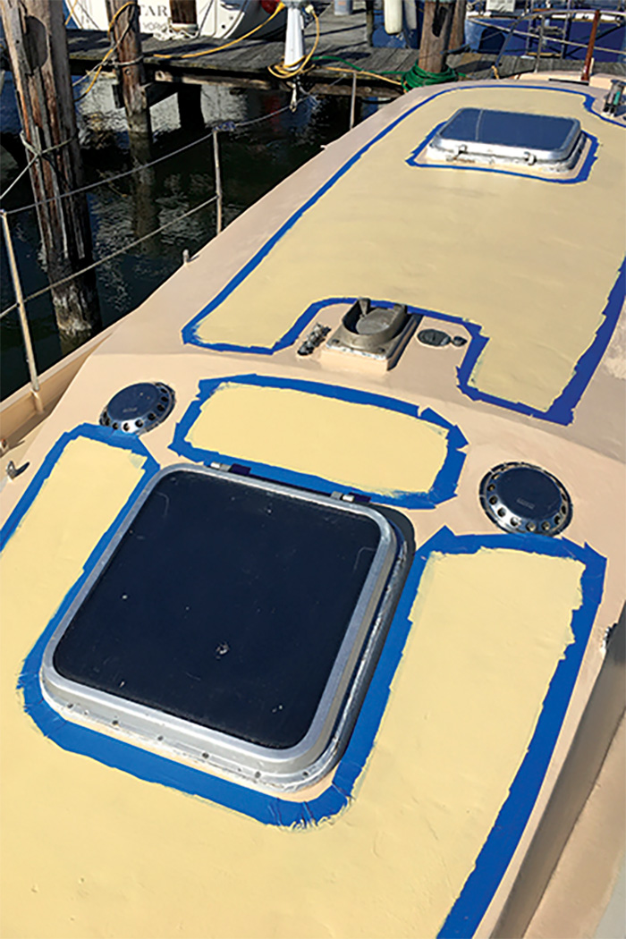 Top of a boat prepped for painting with nonskip and blue tape.