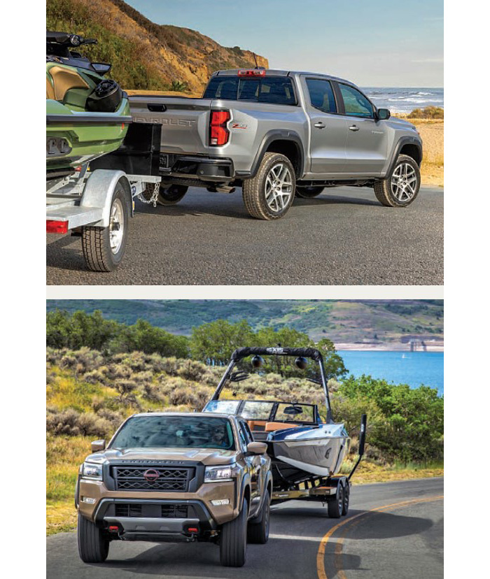 Two silver trucks towing boats