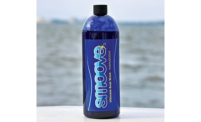 Blue bottle on a white top with water in the background.