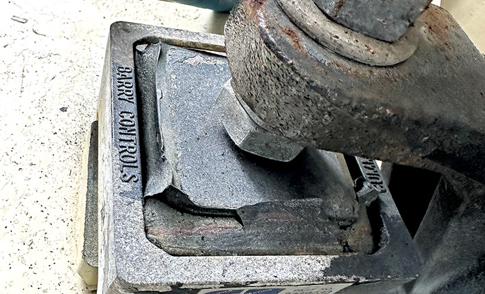 Rusted, cracked and damaged engine mount.