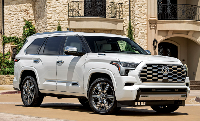 White 437-hp Toyota Sequoia parked on a brick driveway during daylight.