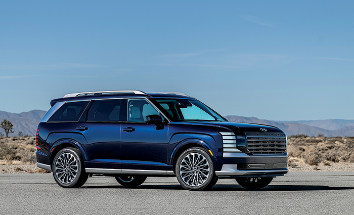 A Navy blue Hyundai all AWD Palisade 2.5T-GDI HEV parked on a desert road during daylight.