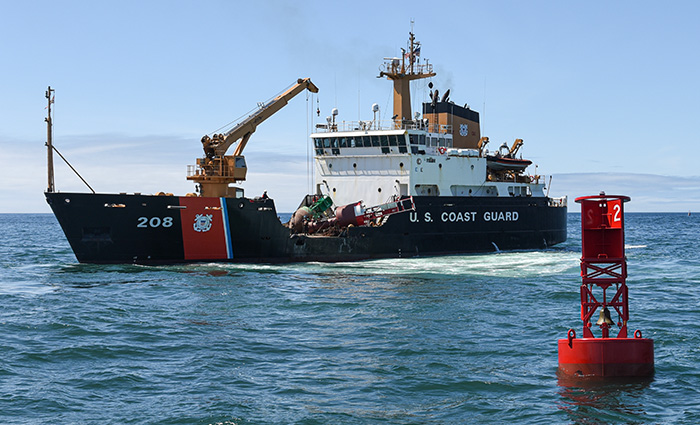 Large black, white and red U.S. Coast Guard vessel out at sea.