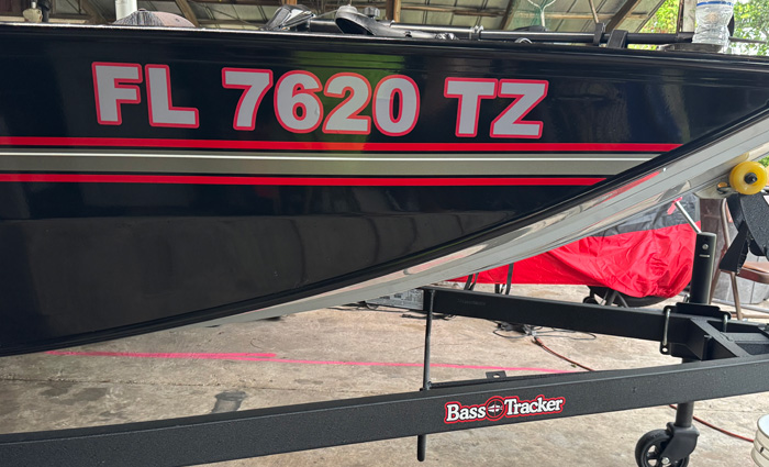 Black, red and silver boat with grey and red lettering.