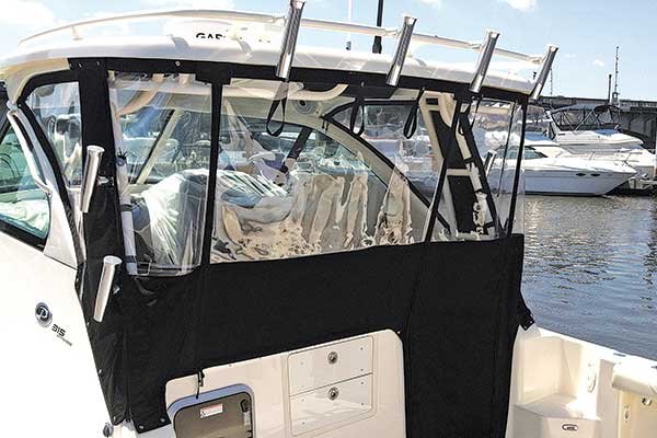 clear and black vinyl  sectional hanging below fishing rod holders on a white powerboat